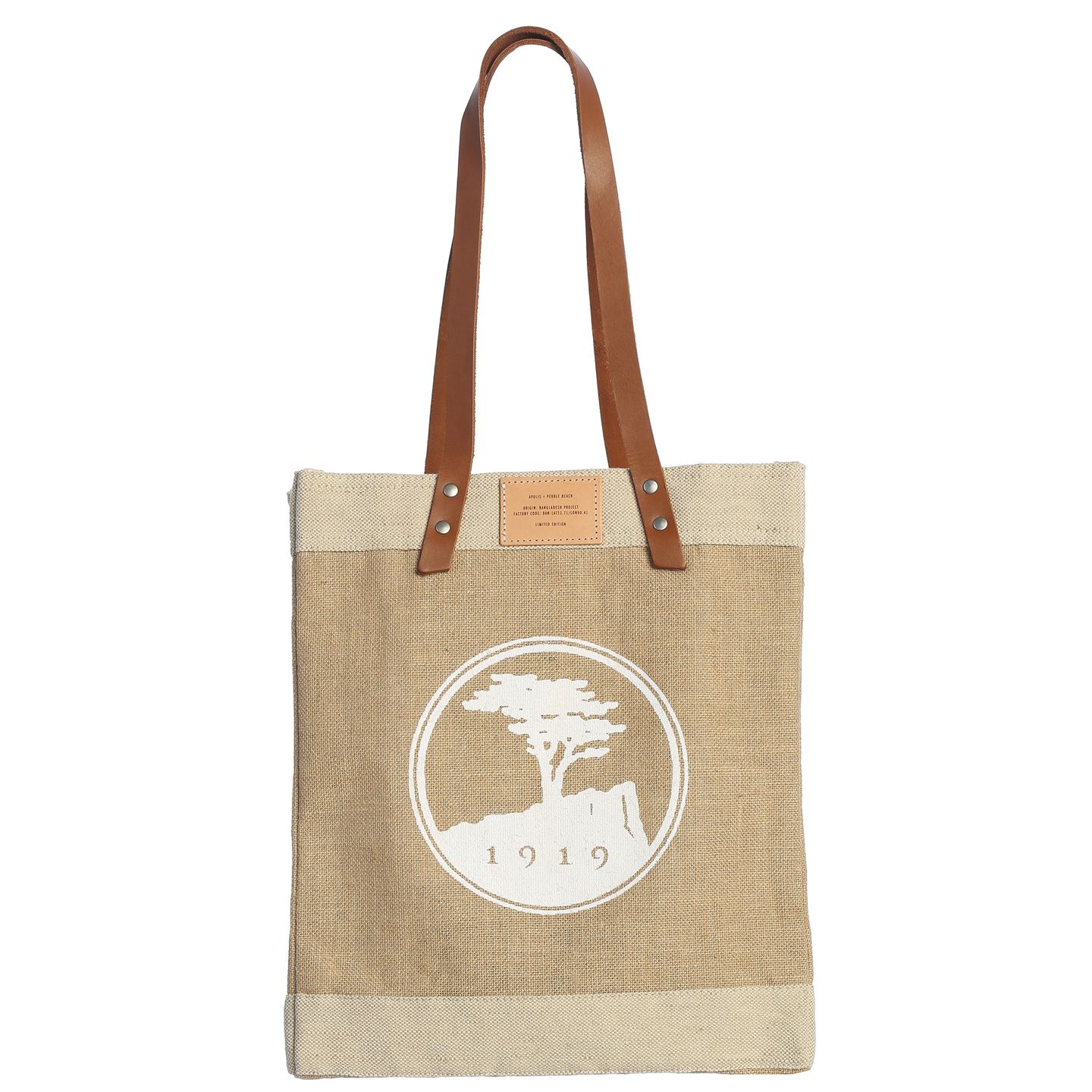 Beige tote bag with leather handles and pebble beach logo on a white background