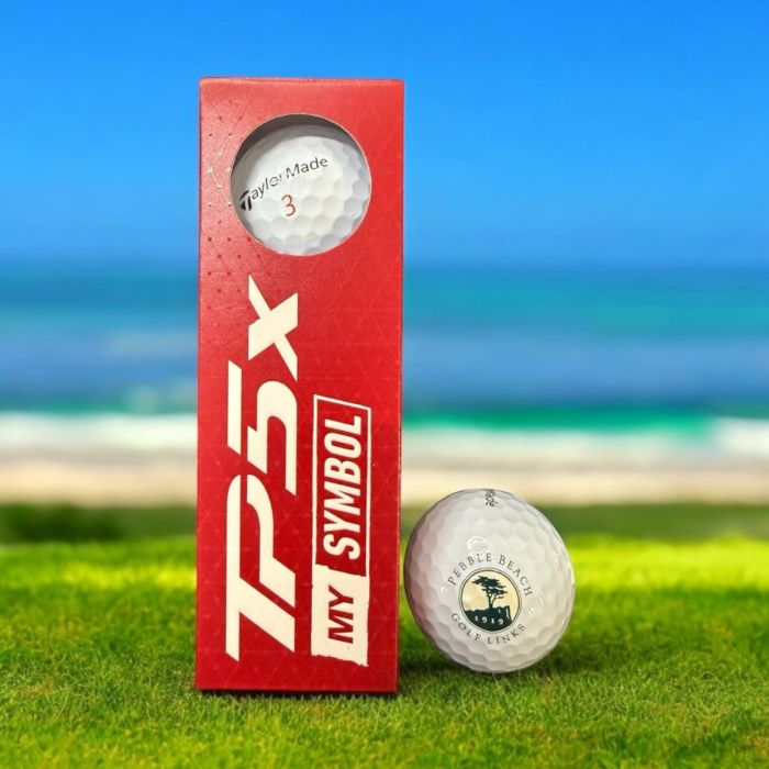 TaylorMade TP5x golf ball packaging with pebble beach golf links logo with a golf ball on grass and ocean background