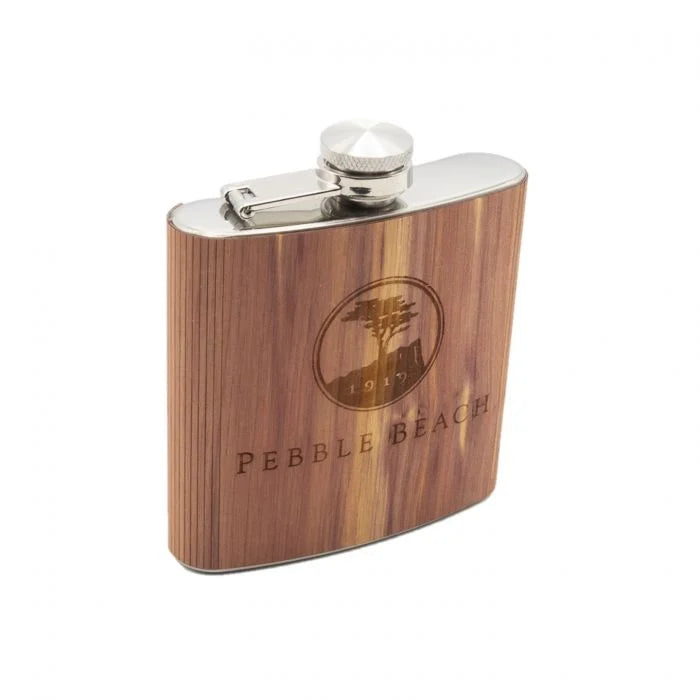 Wooden flask with 'Pebble Beach' branding on a white background
