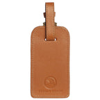 Brown leather luggage tag with 'Pebble Beach' logo on a white background