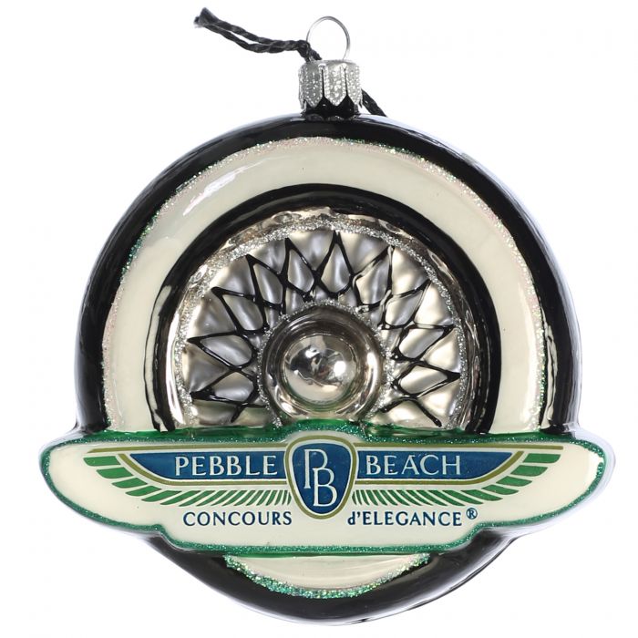 Decorative ornament resembling a car hubcap with 'Pebble Beach Concours d'Elegance' branding.
