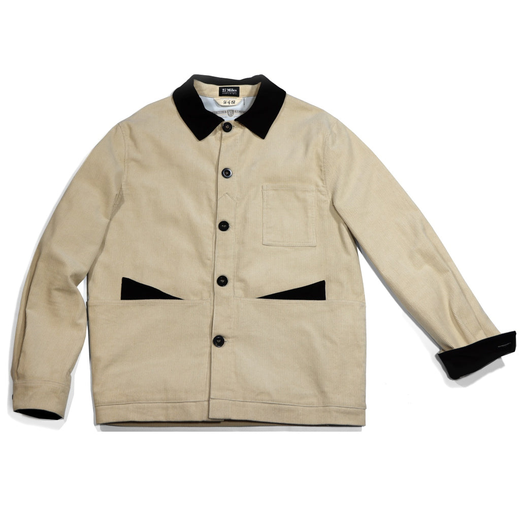 Beige jacket with black collar and cuffs on a white background