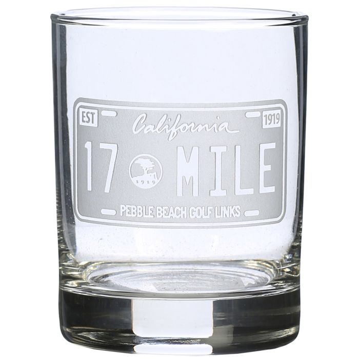 Rocks glass with engraved California 17 Mile Drive license plate design on a white background