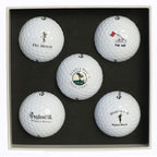 Five golf balls Delmonte golf, Pebble beach golf links, The Hay golf, Spanish bay golf links, and spyglass hill golf course logos in a black display box