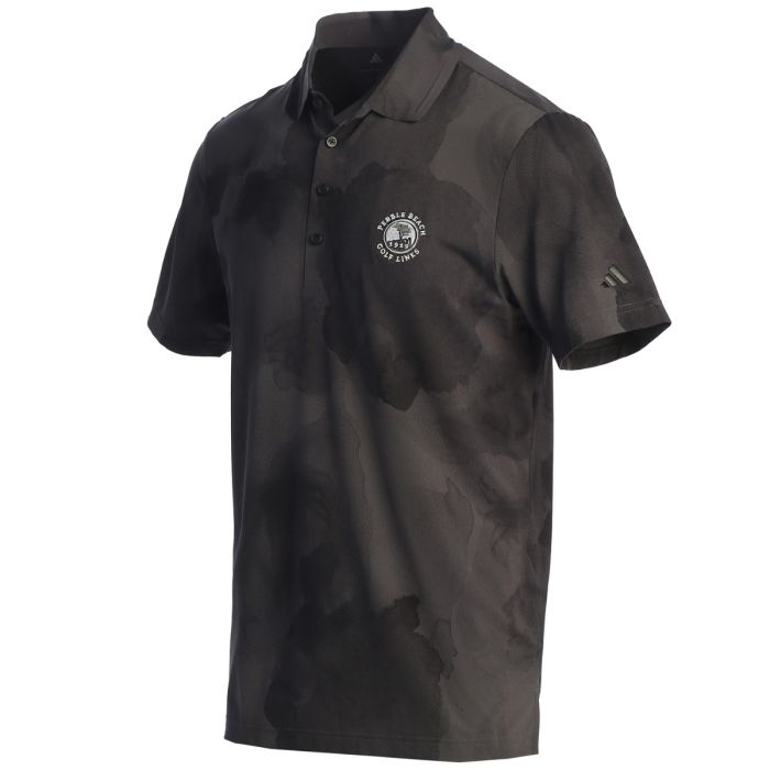 Black camouflage polo shirt with an adidas logo on the sleeve and a pebble beach logo on the chest on a white background