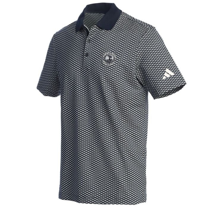 Navy patterned polo shirt with an Adidas logo on the sleeve and a Pebble Beach logo on the chest on a white background