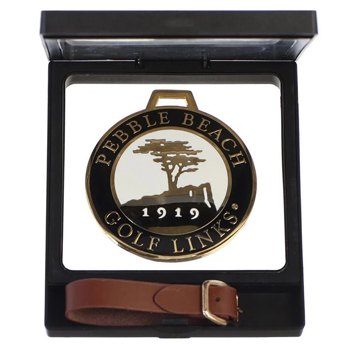 Black bag tag with Pebble Beach Golf Links logo in a black case with a brown strap on a white background