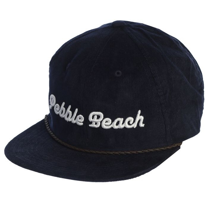 Navy blue corduroy cap with 'Pebble Beach' embroidery in white with a brown leather rope on a white background