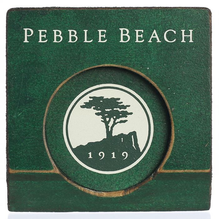 Green wooden putting cup with 'pebble beach' text and logo on inside on a white background.