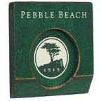 Green wooden putting cup with 'pebble beach' text and logo on inside on a white background.