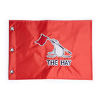 Red flag with 'The Hay' logo on a white background