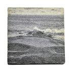 Square grey wood coaster with an image with a golf course and water on a white background