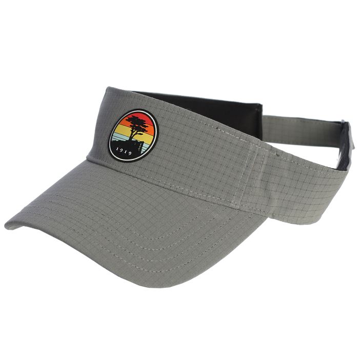 Gray visor with a colorful sunset and a pebble beach logo on a white background
