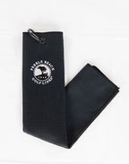 Black textured golf towel with Pebble Beach Golf Links logo on a white background