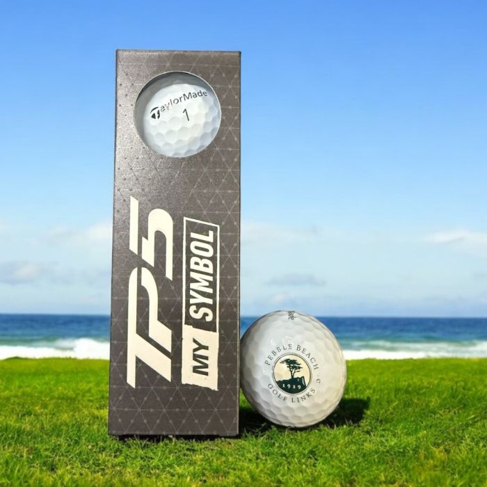 TaylorMade TP5 Golf ball with pebble beach logo with a golf ball on grassy area with ocean view
