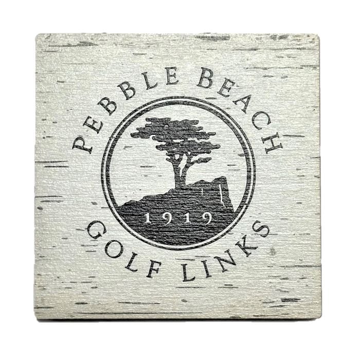 Pebble Beach Golf Links logo on a wooden coaster with a white background