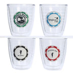 Four clear tumblers a green pebble beach golf links, blue spyglass hill, black del monte golf, and a red Spanish bay poker chip logos on a white background