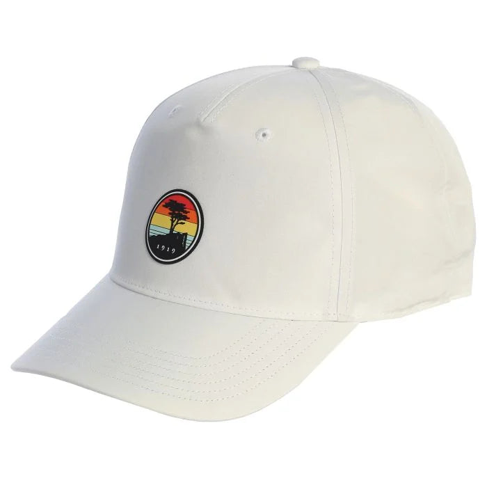 White cap with a colorful sunset patch featuring a pebble beach logo on a white background